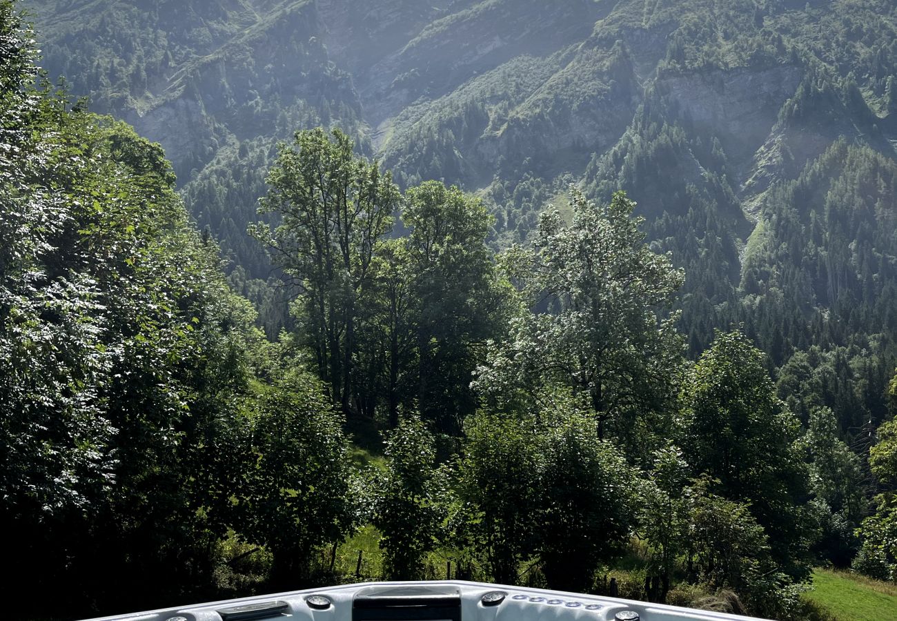 Outdoor hot tub with panoramic views of the alpine mountains
